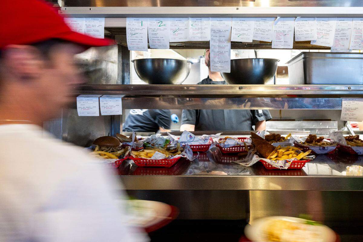 Staff at Tides Tavern work through the lunch rush on Friday, Sept. 8, 2023, in Gig Harbor, Wash.