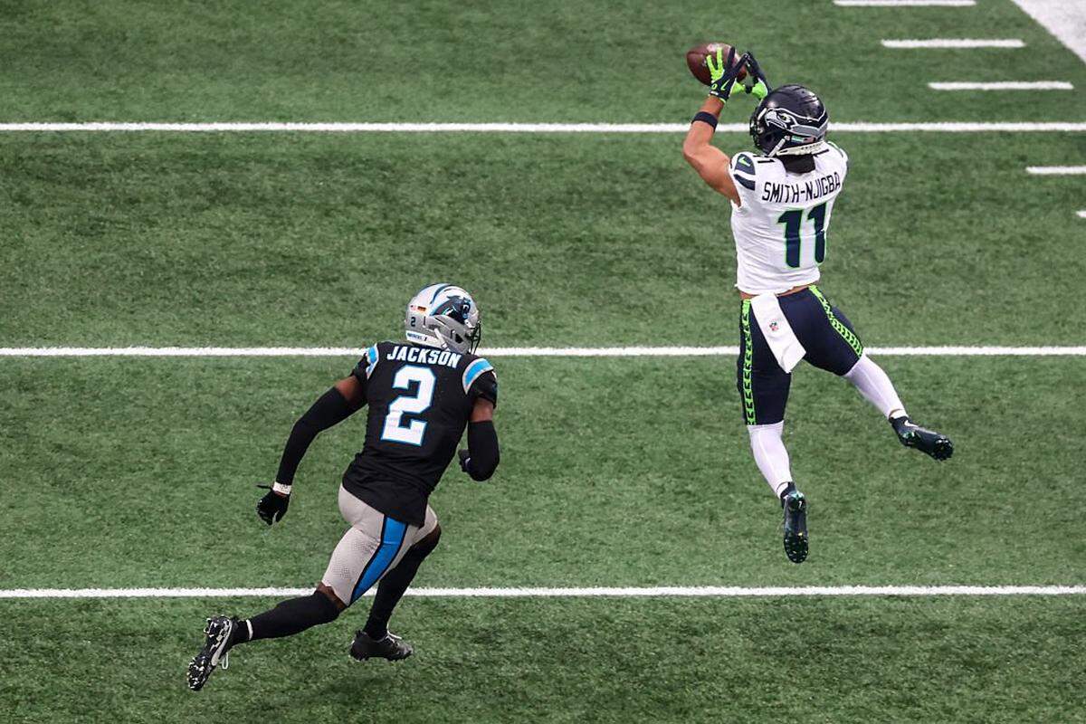 CHARLOTTE, NORTH CAROLINA - DECEMBER 28: Jaxon Smith-Njigba #11 of the Seattle Seahawks catches a pass in front of Mike Jackson #2 of the Carolina Panthers during the first quarter at Bank of America Stadium on December 28, 2025 in Charlotte, North Carolina. (Photo by David Jensen/Getty Images)