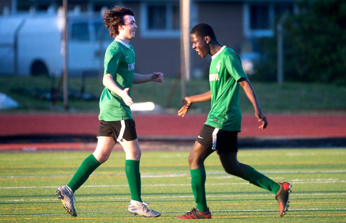Tumwater junior forward Sam Southworth (left) and sophomore forward Sambou Jadama celebrate Southworth’s goal during a soccer match against the Rochester Warriors at Tumwater District Stadium in Tumwater, Washington, on Friday, April 16, 2021.