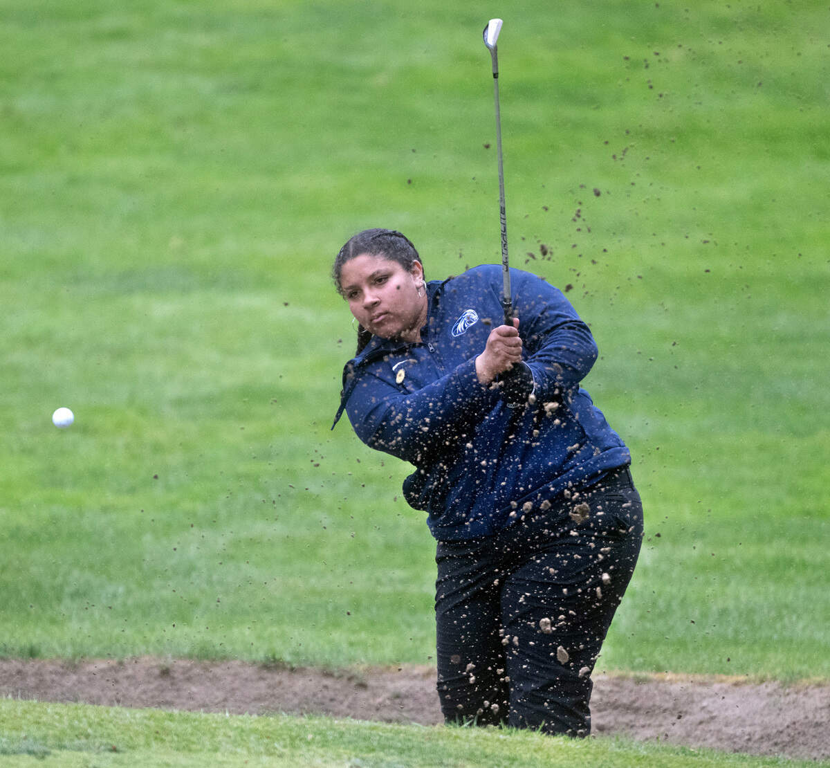 Meadowdale’s Samarra Smith blasts out of the sand trap on the 18th hole during the opening day of the 3A Girls Golf State Championships at Eagles Pride Golf Course in DuPont, Washington, on Tuesday, May 21, 2024.