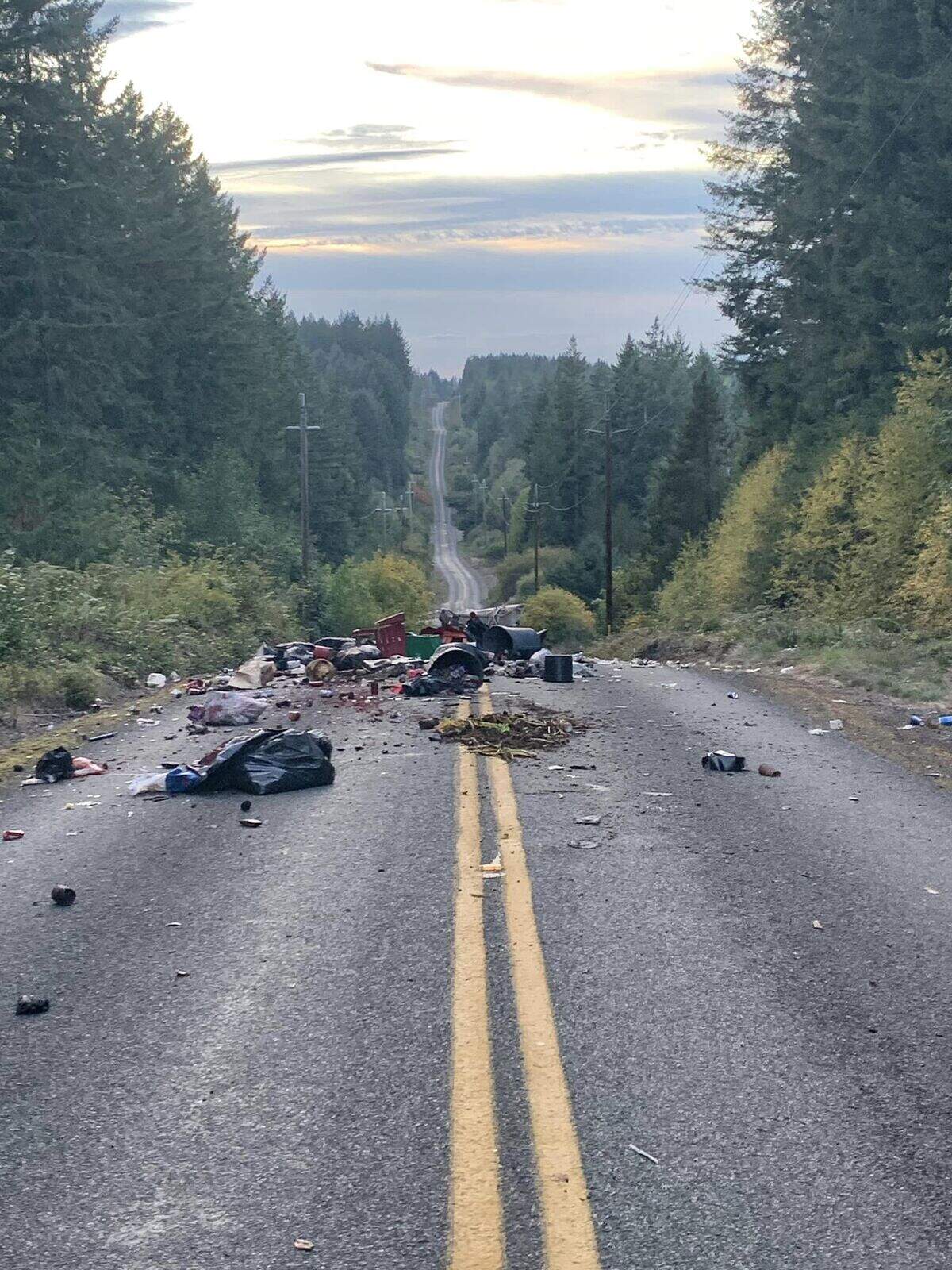 A Key Peninsula driver found a large load of garbage dumped near 144th Street and 180th Avenue. It blocked both lanes of travel until a public works employee with Pierce County cleaned it up.
