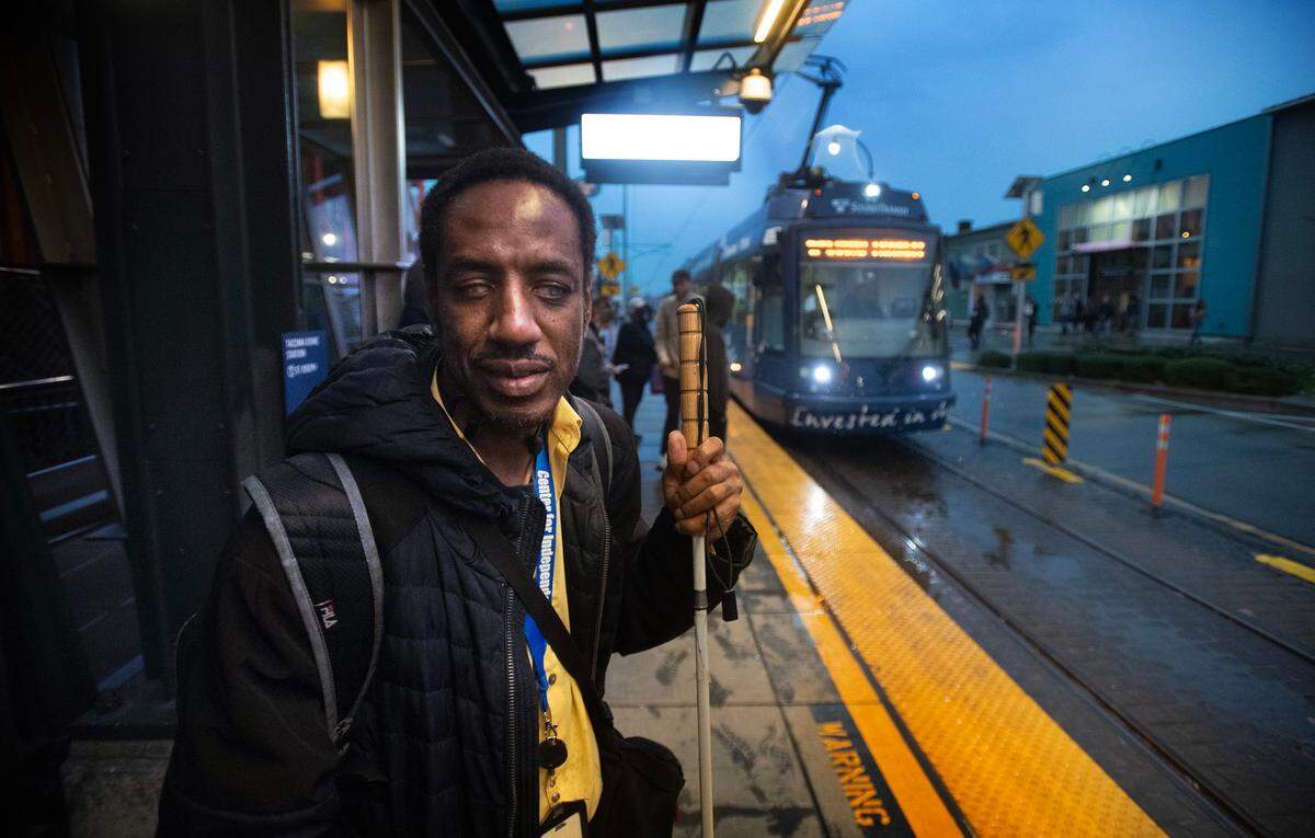 Amin “Tony” Hester, the chair of the Tacoma Area Commision on Disabilities, waits to catch the Tacoma Light Rail T-Line at the Tacoma Dome Station in Tacoma, Washington, on Thursday, Nov. 9, 2023.