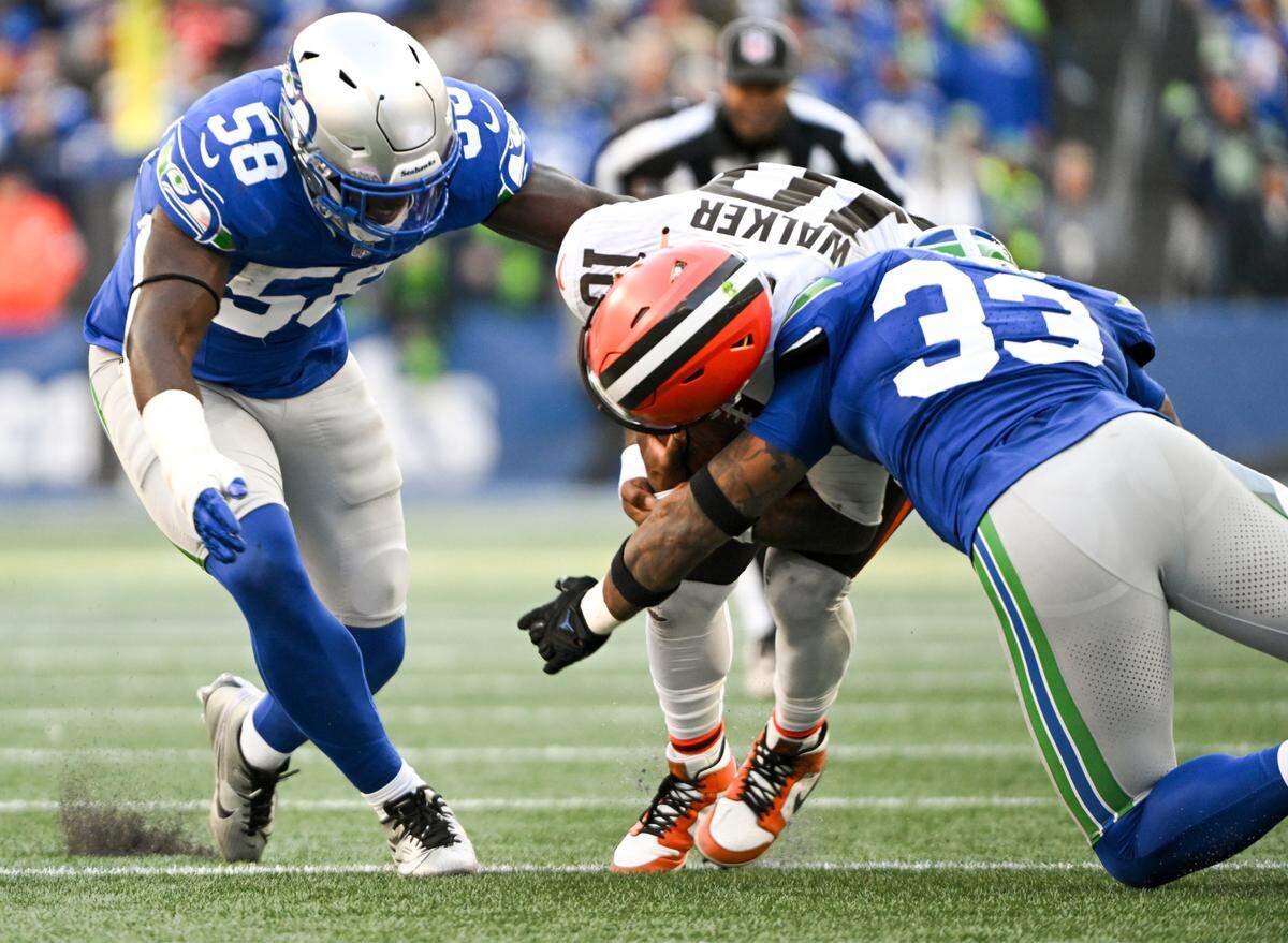 Cleveland Browns quarterback PJ Walker (10) is brought down by Seattle Seahawks safety Jamal Adams (33) and linebacker Derick Hall (58) during the third quarter of the game at Lumen Field, Sunday, Oct. 29, 2023, in Seattle, Wash.