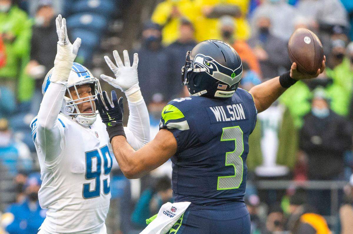 Seattle Seahawks quarterback Russell Wilson (3) attempts a pass as Detroit Lions linebacker Julian Okwara (99) defends during the first quarter of an NFL game on Sunday, Jan. 2, 2022, at Lumen Field in Seattle.