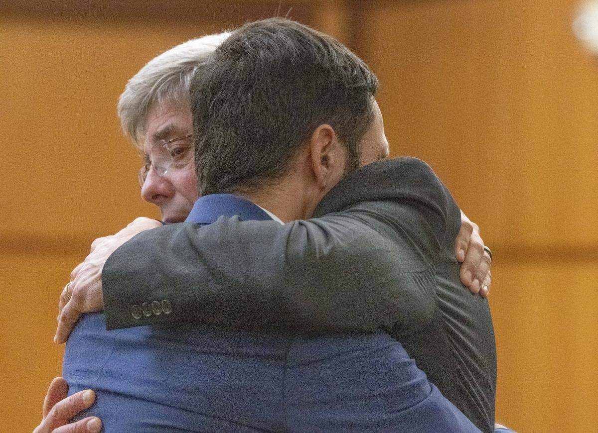 Tacoma Police officer Christopher â€œShaneâ€ Burbank (r) gets a hug from his attorney Wayne Fricke after he is declared not guilty for any charges related to the March 2020 killing of Manny Ellis in Pierce County Superior Court in Tacoma Thursday, December 21, 2023. Officers Matthew Collins and Timothy Rankine were both declared not guilty for all charges regarding his death. 225808