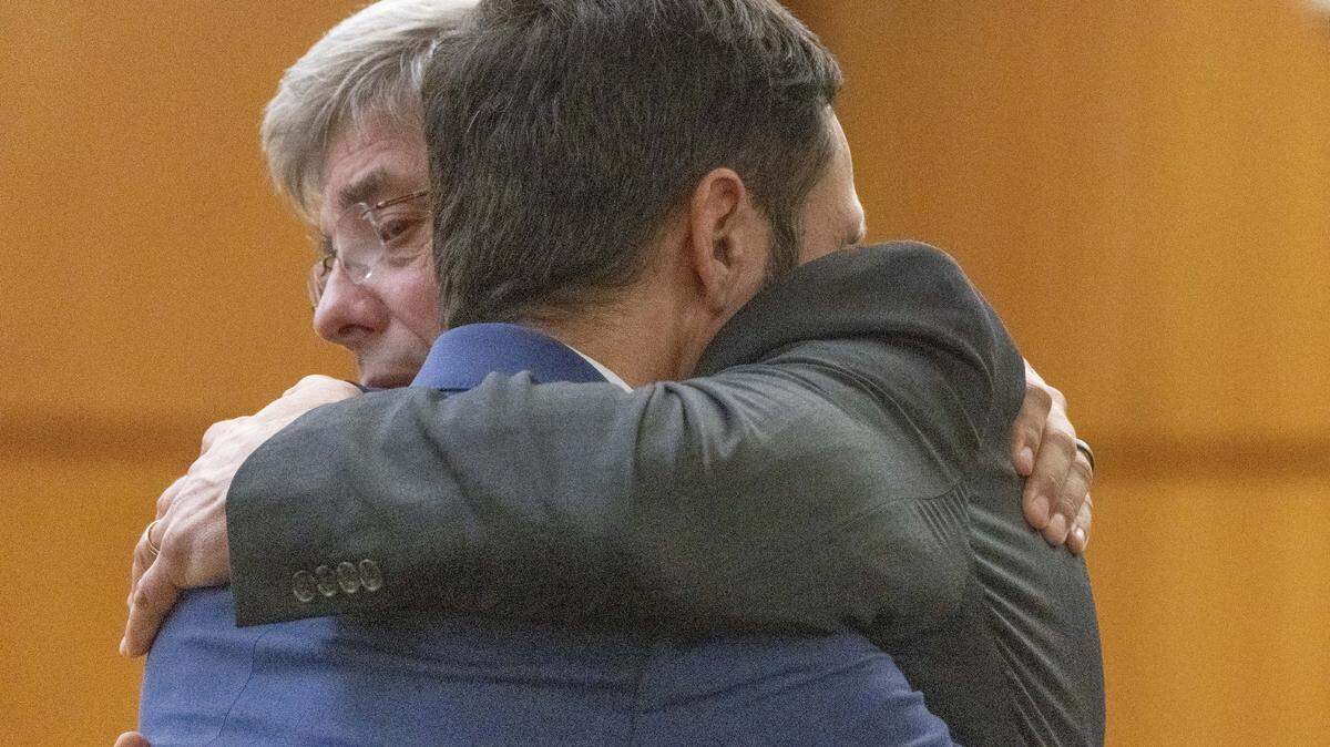 Tacoma Police officer Christopher Burbank (r) gets a hug from his attorney Wayne Fricke after he is declared not guilty for any charges related to the March 2020 killing of Manny Ellis in Pierce County Superior Court in Tacoma Thursday, December 21, 2023. Officers Matthew Collins and Timothy Rankine were both declared not guilty for all charges regarding his death. 225808