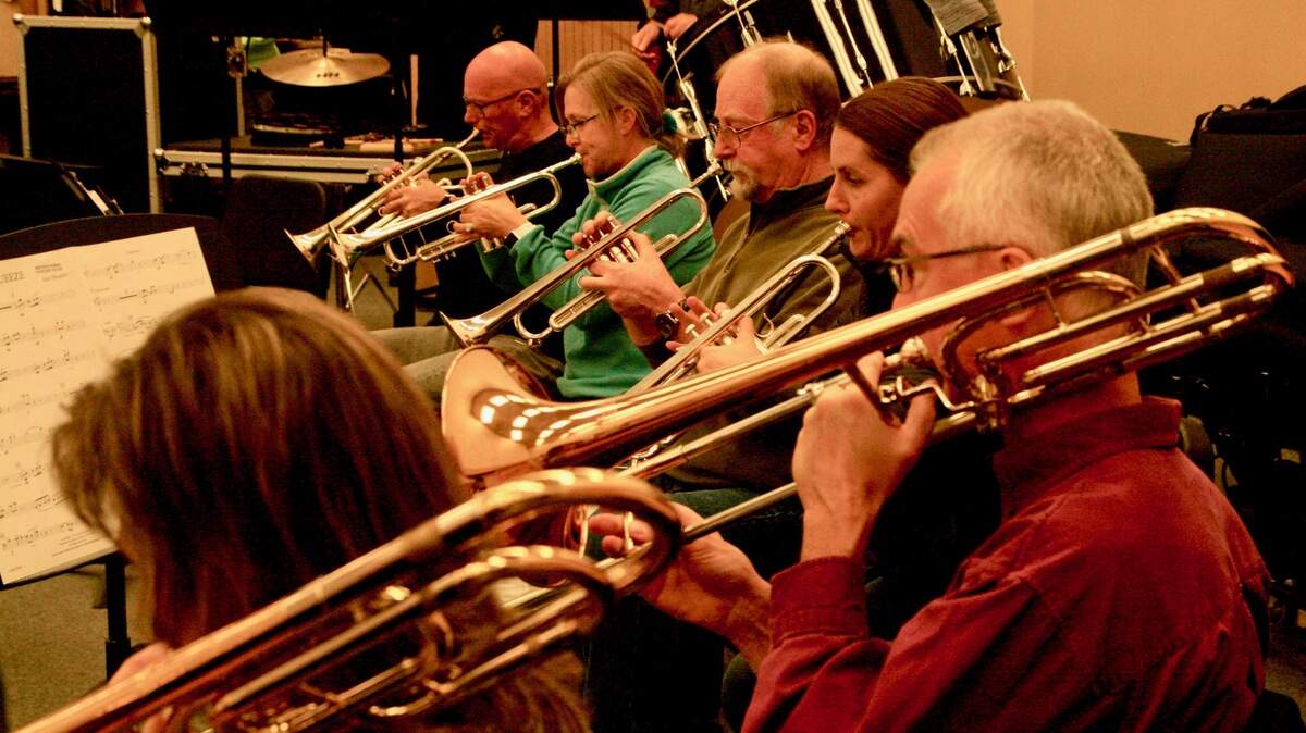 The brass section of Harbor Winds concert band rehearsed. From center back on trumpets, Keith Chamberlain, Lynne Everling, Steven Stewart, and Laura Davis and, front, on trombones Paul Bogataj and Becky Sharrett.