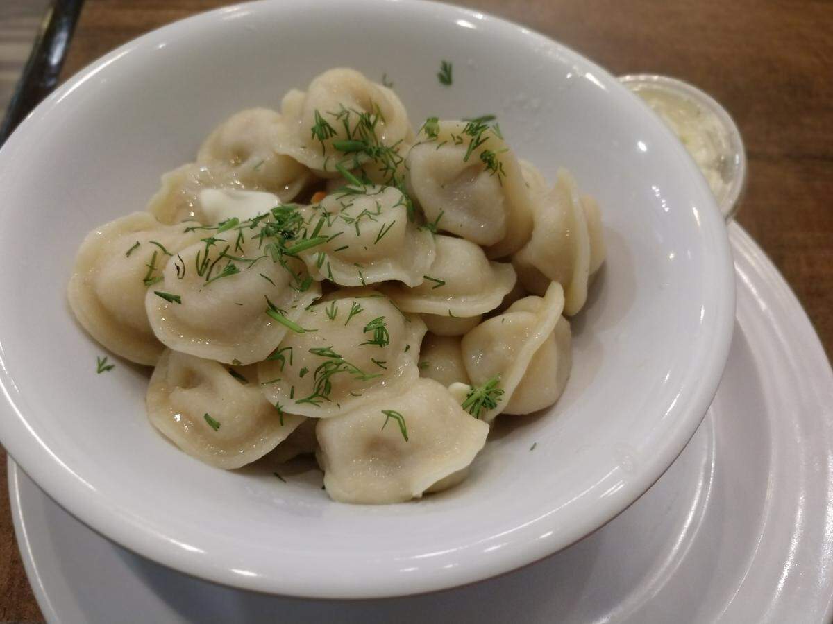 Pelmeni, European dumplings, with fresh dill and butter from Marvel Bay Cafe. Sour cream is on the side.