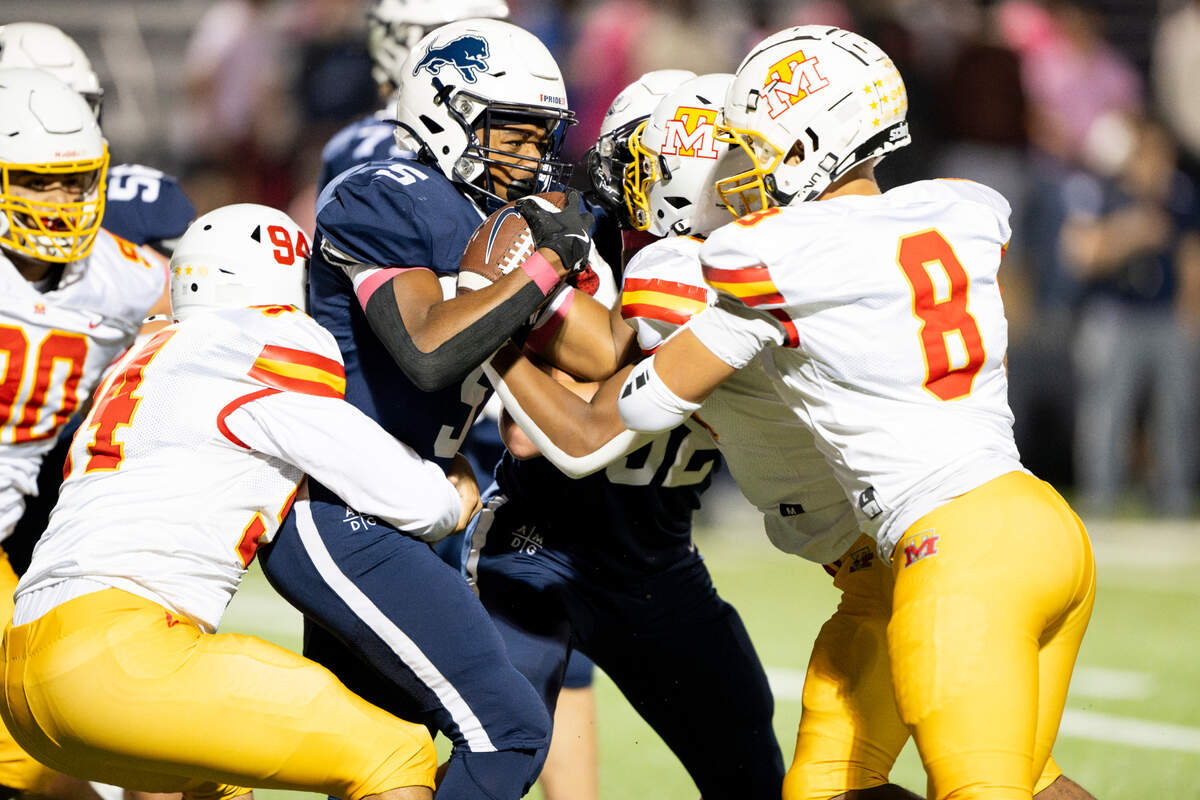 Bellarmine Prep running back Elias Givens (5) runs into a wall of Mount Tahoma defenders during the first half of the game at Bellarmine Preparatory School, on Friday, Oct. 11, 2024, in Tacoma, Wash.