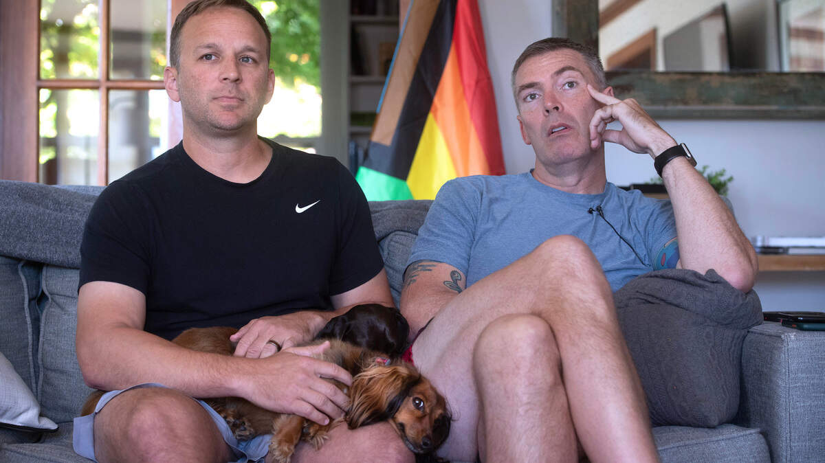 Josh Hargrave (left) and his husband, Joe Hargrave, had their Pride flag stolen and their flagpole destroyed during a weekend theft and vandalism spree on pride flags in eight locations throughout the north end of Tacoma, Washington. The couple is shown at their home on June 15, 2023.