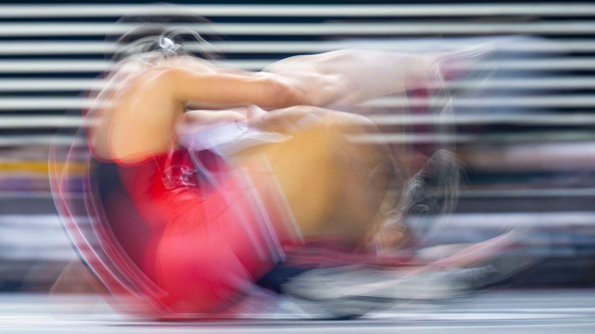 Yelm’s Brayden Platt rolls Kentlake’s Caden Loudermilk over and across the mat during their 285-pound 3A consolation match at Mat Classic XXXIII on Friday, Feb. 18, 2022, in Tacoma, Wash.