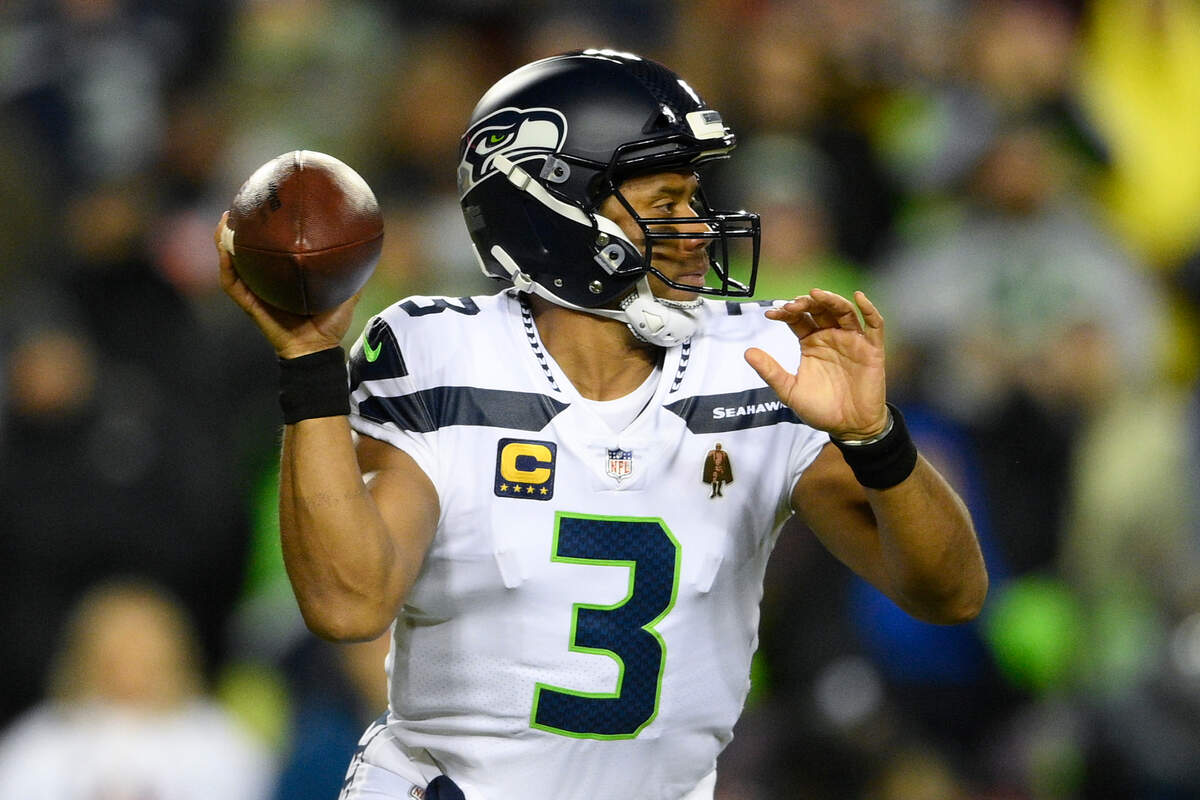 Seattle Seahawks quarterback Russell Wilson (3) looking downfield to pass the ball during the first half of an NFL football game against the Washington Football Team, Monday, Nov. 29, 2021, in Landover, Md. (AP Photo/Nick Wass)