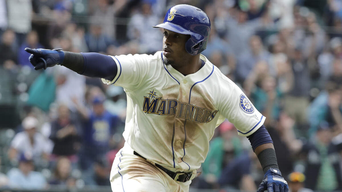 Seattle Mariners' Jean Segura points to the dugout as he runs to first after he hit a walkoff RBI-single to score Dee Gordon and give them a victory over the Detroit Tigers in the 11th inning of a baseball game, Sunday, May 20, 2018, in Seattle. (AP Photo/Ted S. Warren)