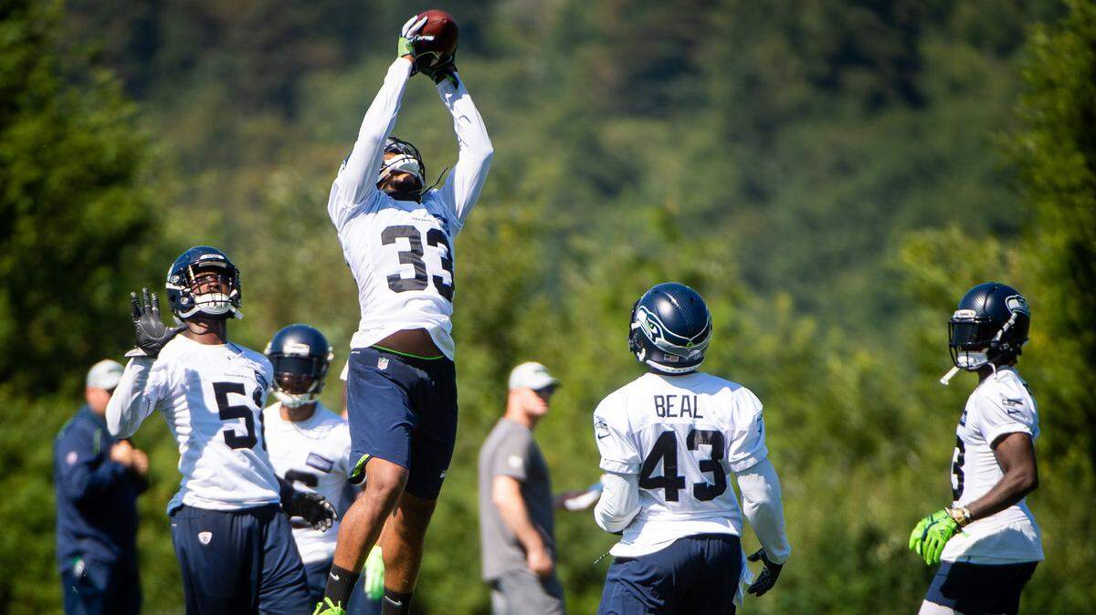 Tedric Thompson (33), the 2017 draft pick currently replacing holdout All-Pro Earl Thomas as the Seahawks’ free safety, pulls down a catch during the first day of training camp at the Virginia Mason Athletic Center in Renton on Thursday. Thompson praises Thomas for how much the six-time Pro Bowl selection continues to help him, from afar.
