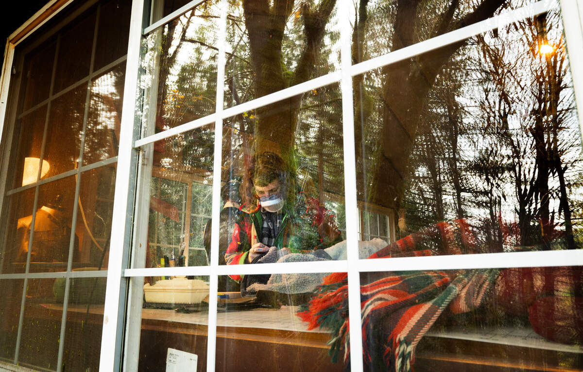 Rheanna Pless works in the Rhecycled clothing workshop in Belfair, Washington, on Friday, Nov. 8, 2024.