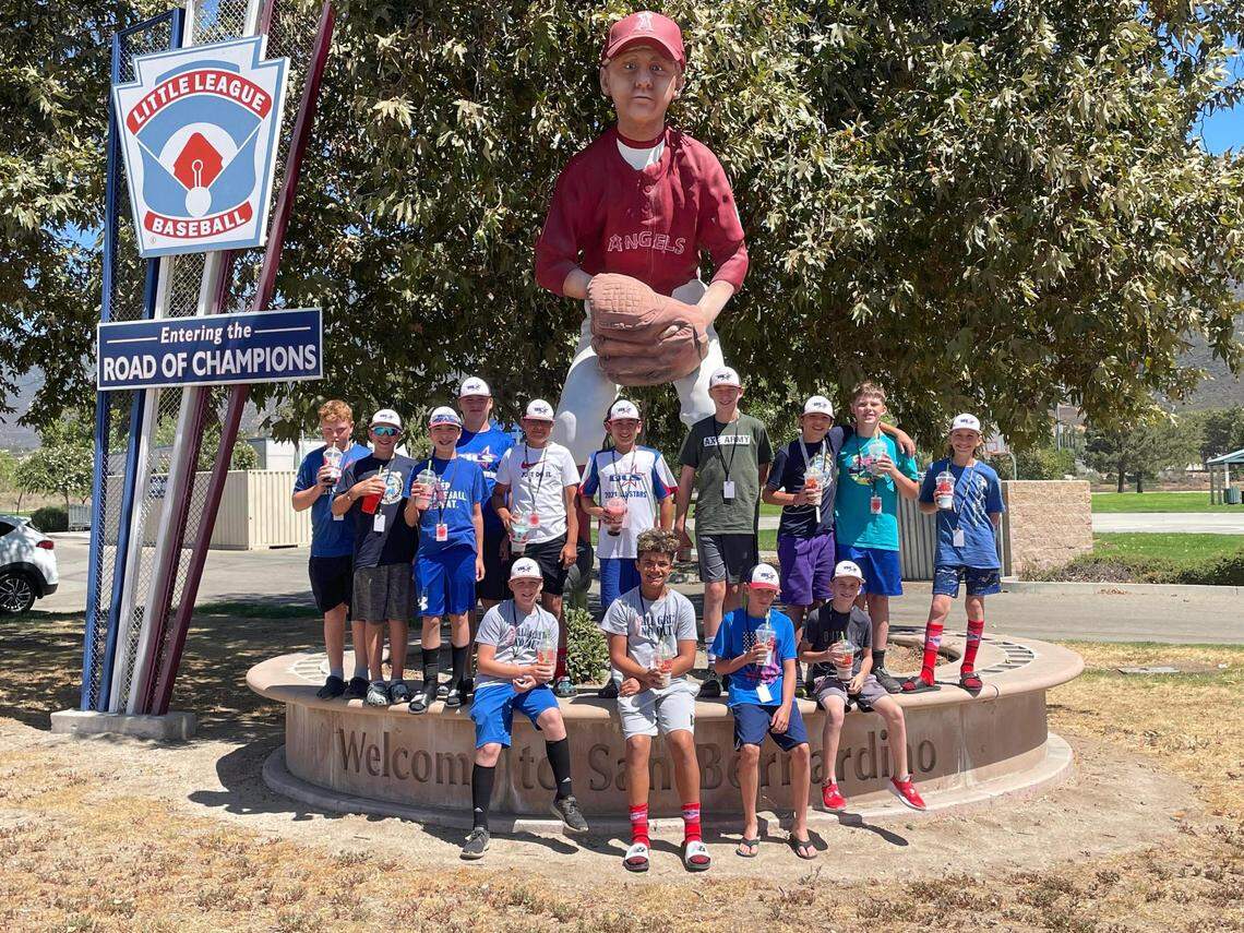 The Bonney Lake-Sumner Little League all stars pose in front of a baseball player statue in San Bernadino, CA. The team won the Northwest regional tournament to become the first team made up exclusively of Pierce County residents to play in the Little League World Series.