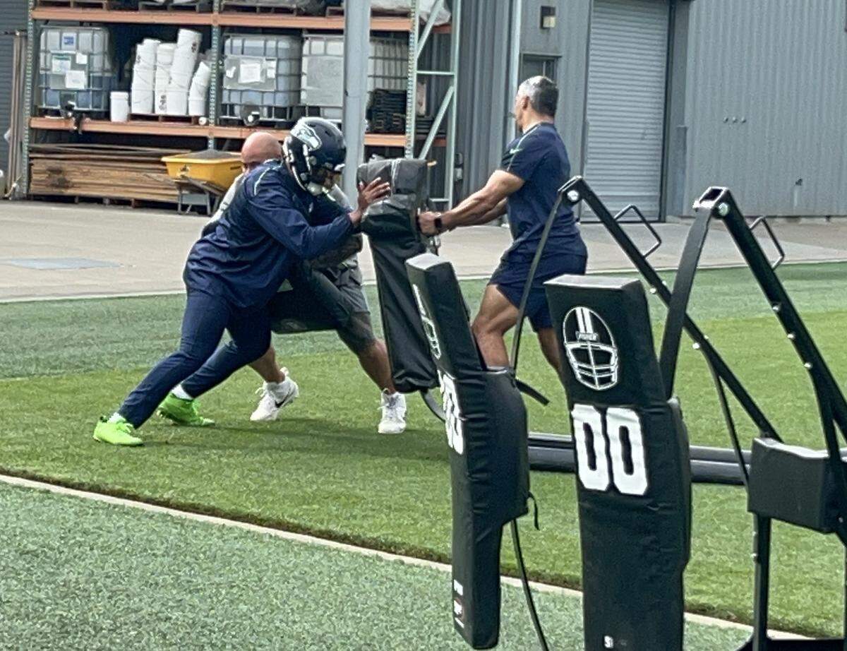 Linebacker Uchenna Nwosu works with assistants on a side field in his return from knee surgery, during the 20th practice of the Seahawks’ preseason Sunday, Aug. 17, 2025, at the Virginia Mason Athletic Center in Renton.
