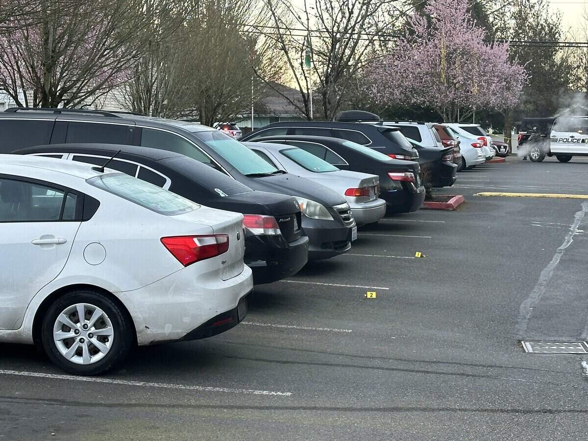 Evidence markers are shown at the scene of a double shooting in the parking lot of a Puyallup apartment complex in the 700 block of 43rd Avenue Southeast. Police said two men were shot after a dispute at a party early Saturday, March 16, 2024.