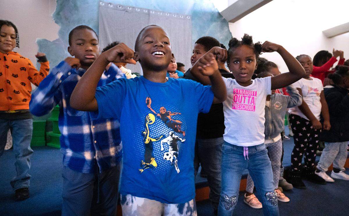 Josiah Milligan (from left), Dae’Shawn Johnson, and Kendall Milligan sing and dance during the Music and Movement morning activities at the Multicultural Child and Family Hope Center’s Community Hall in the Hilltop neighborhood of Tacoma, Washington, on Wednesday, Nov. 1, 2023. The center is on a multi-million dollar capital campaign to expand their location and services.