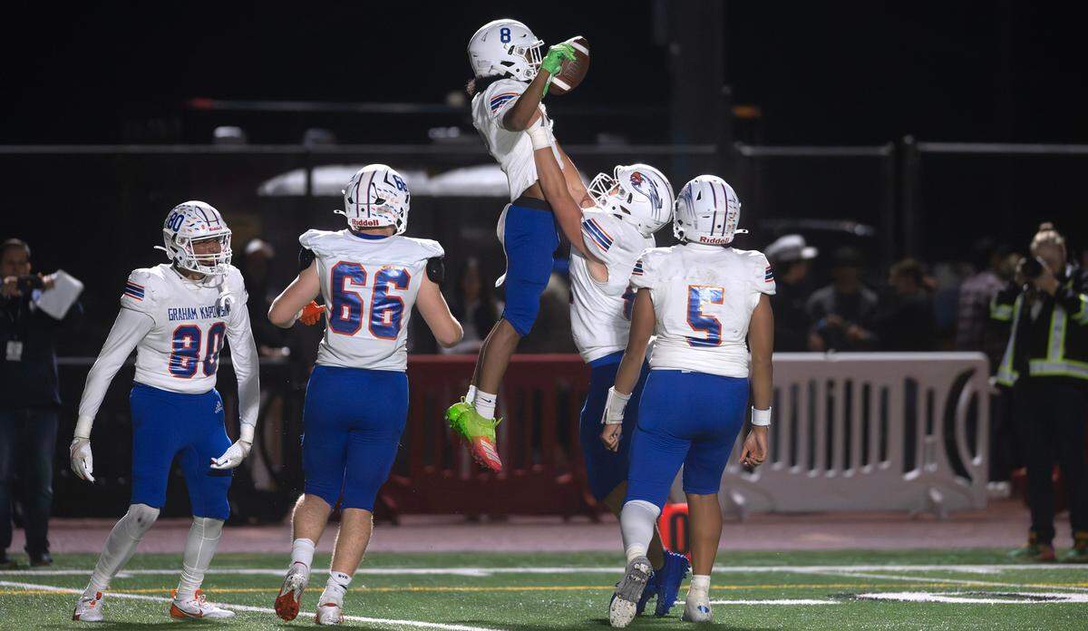 Graham Kapowsin wide receiver Mazaia Roberson celebrates his touchdown catch with teammates during Friday night’s football game against the Yelm Tornados at Yelm High School in Yelm, Washington, on Oct. 4, 2024.