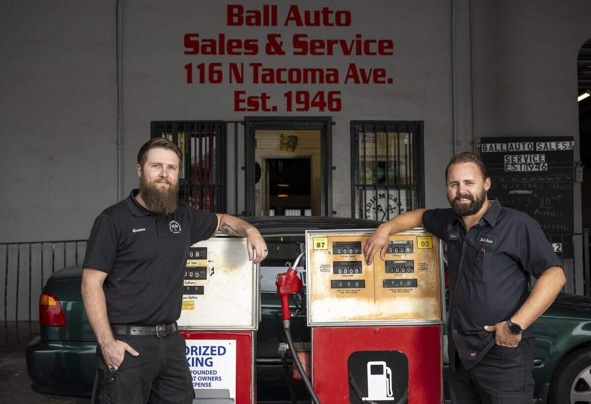 Stadium Garage owner Quentin Luthi, left, and Ball Auto owner Drew Barnett stand outside of Ball Auto for a portrait on Monday, June 29, 2026, in Tacoma, Wash. The auto shop, which houses Stadium Garage on its lower floor, celebrated its 80th anniversary this year.