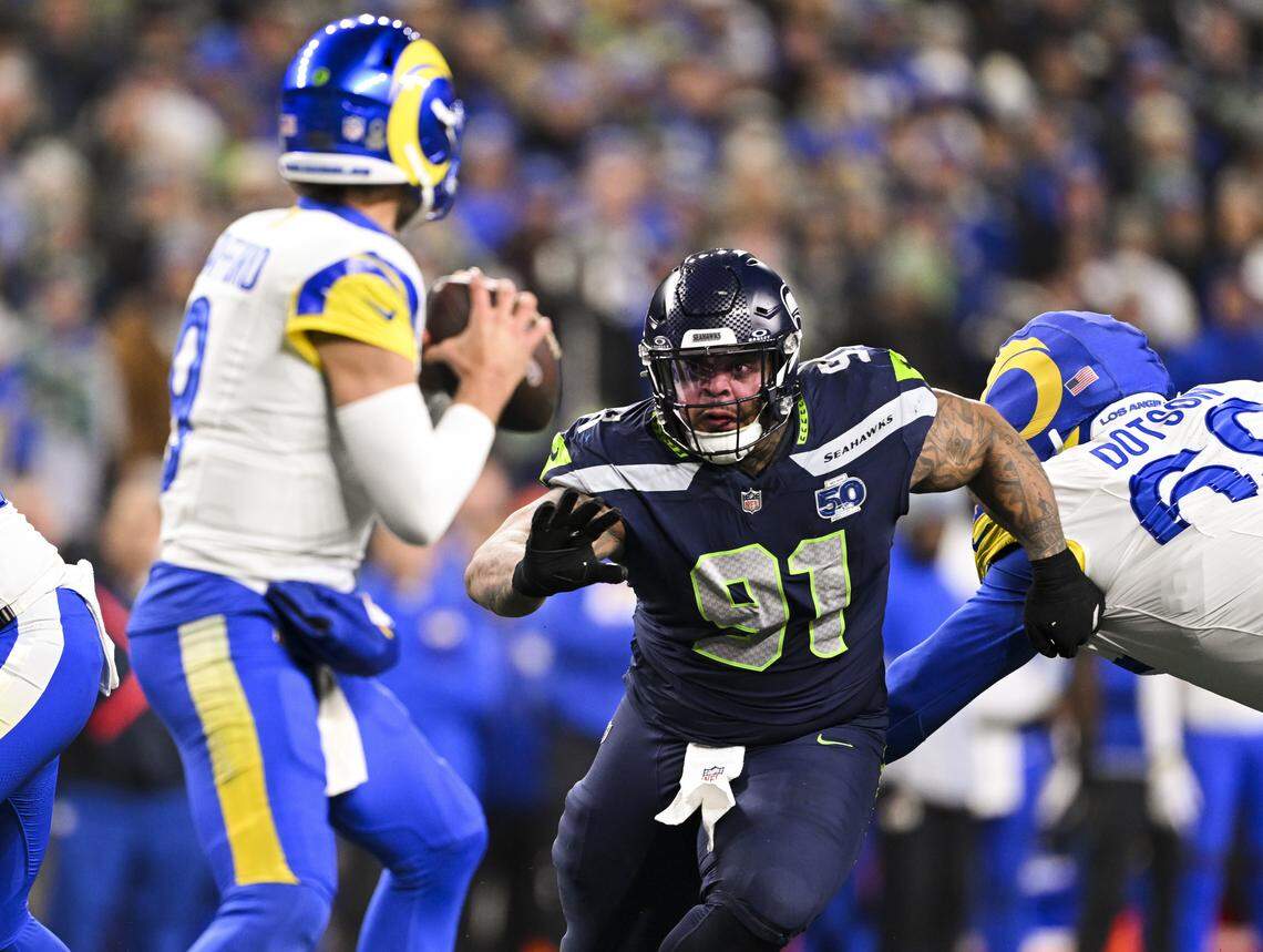 Seattle Seahawks defensive tackle Byron Murphy II (91) bares down as Los Angeles Rams quarterback Matthew Stafford (9) as he drops back during the fourth quarter of the NFC Championship game at Lumen Field, on Sunday, Jan. 25, 2026, in Seattle.