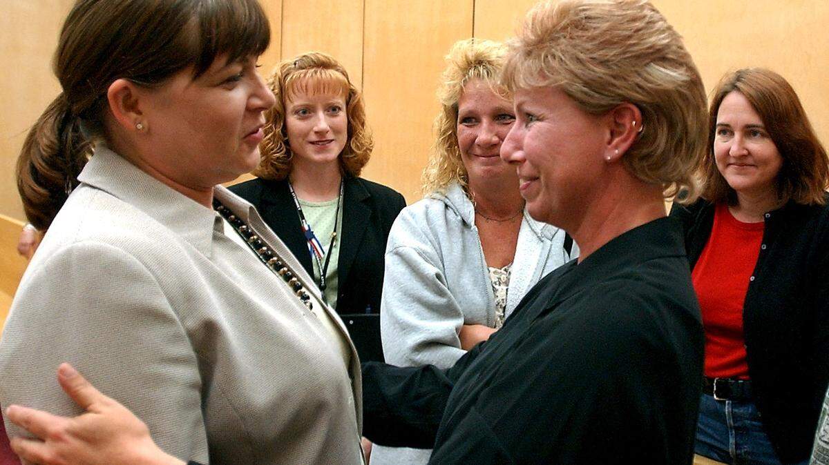 Karyl Bushell, second from right, the mother of Melinda Mercer, gives a hug to deputy prosecutor Barbara Corey-Boulet after jurors convicted serial killer Robert Lee Yates, Jr. of aggravated first-degree murder for killing Mercer and Connie Lynn LaFontaine Ellis in 1997 and 1998 and dumping their bodies in Pierce County. Photo was taken in Tacoma on Sept. 19, 2002.