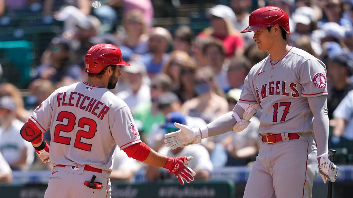 Los Angeles Angels’ David Fletcher (22) is greeted at the plate by Shohei Ohtani (17) after Fletcher hit a solo home run during the third inning of a baseball game against the Seattle Mariners, Sunday, July 11, 2021, in Seattle. (AP Photo/Ted S. Warren)