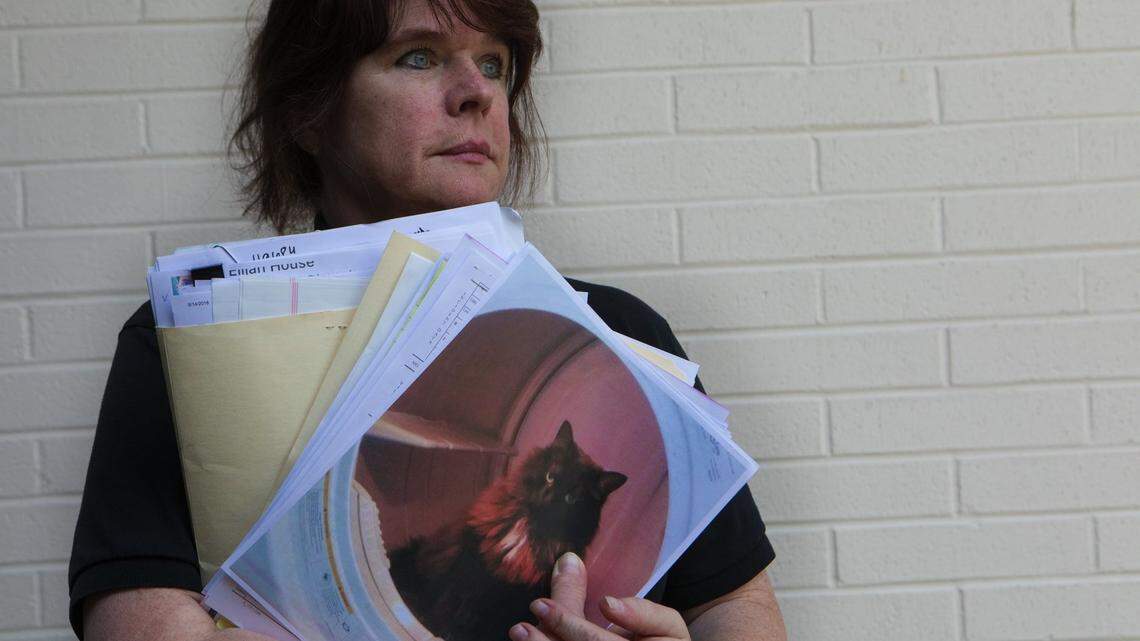 Erika Johnson, animal-cruelty investigator with Thurston County Joint Animal Services, holds a photo of Callie, the cat that belonged to Angi and Pat Swan of Olympia and was found dead in a park.