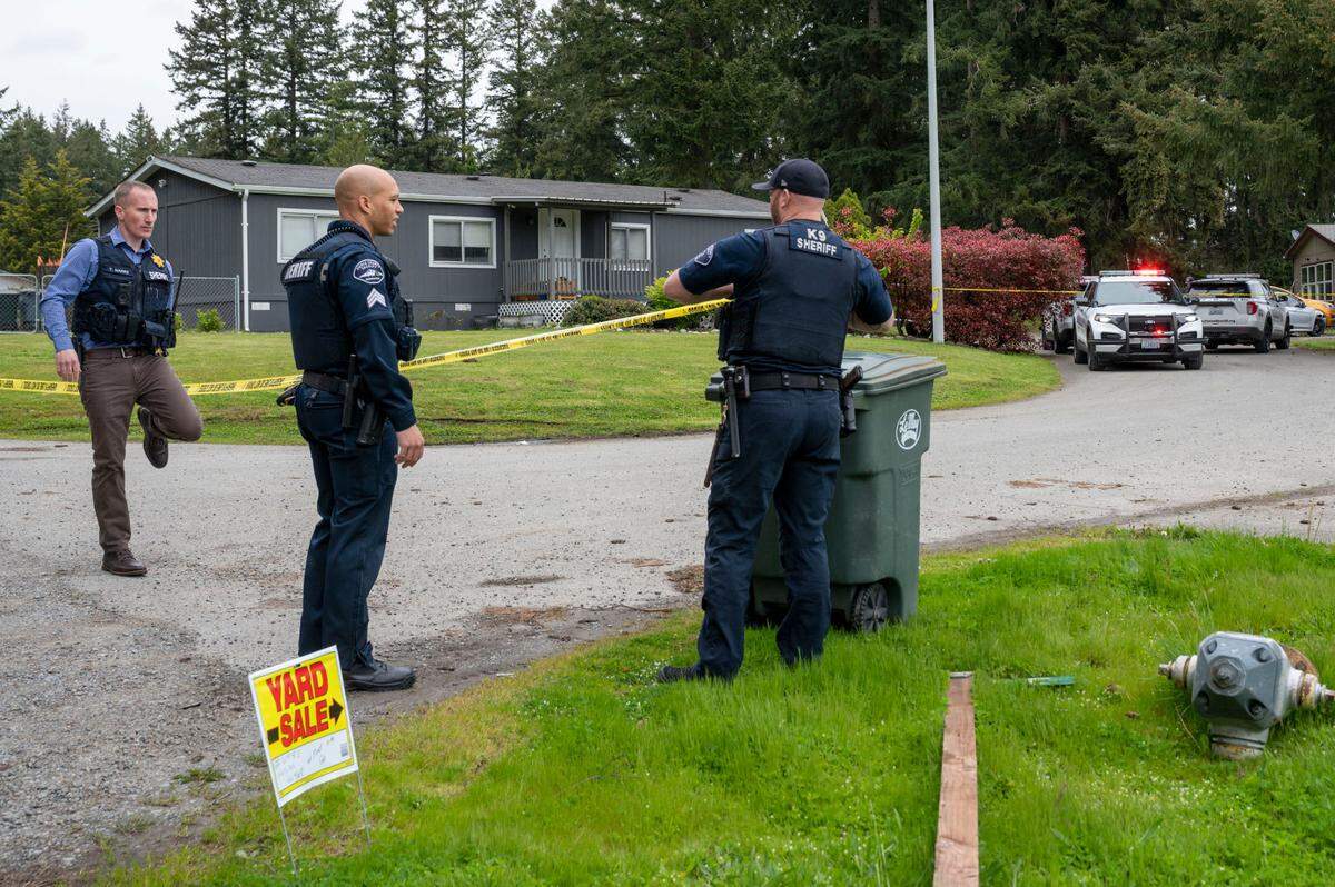 Pierce County Sheriff’s Department deputies tape off the scene after a deputy-involved shooting on 161st Street East and 62nd Avenue near Frederickson on Thursday, May 12, 2022.
