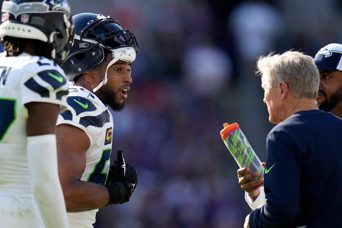 Seattle Seahawks linebacker Bobby Wagner talks with head coach Pete Carroll, right, during the first half of an NFL football game against the Baltimore Ravens, Sunday, Nov. 5, 2023, in Baltimore. (AP Photo/Alex Brandon)