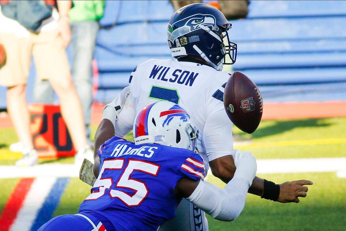 Buffalo Bills’ Jerry Hughes (55) knocks the ball away from Seattle Seahawks’ Russell Wilson (3) to force a fumble during the second half of an NFL football game Sunday, Nov. 8, 2020, in Orchard Park, N.Y. The Bills recovered the ball. (AP Photo/Jeffrey T. Barnes)