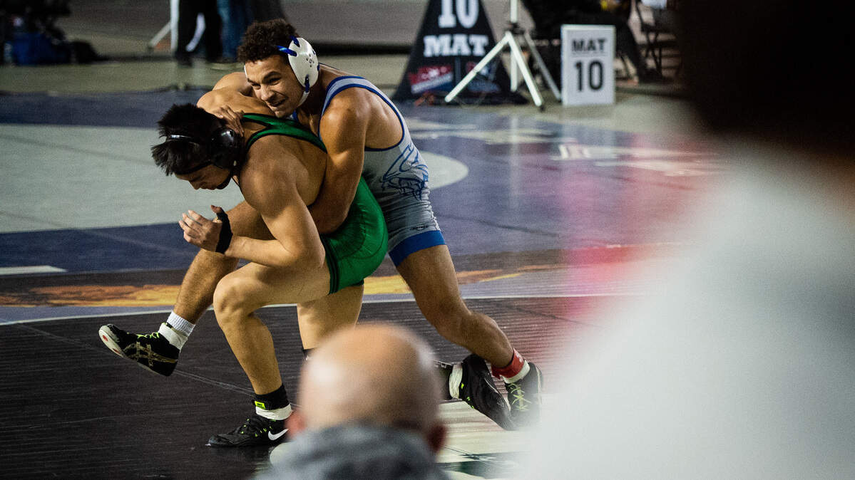 Curtis’ Adrian St Germain wrestles Kentwood’s Alexande Long in the 152lb finals match during Mat Classic XXXI at the Tacoma Dome in Tacoma, Wash., on Saturday, Feb. 16, 2019.
