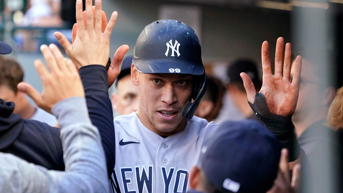 New York Yankees’ Aaron Judge is congratulated after scoring against the Seattle Mariners during the first inning of a baseball game Wednesday, July 7, 2021, in Seattle. (AP Photo/Elaine Thompson)