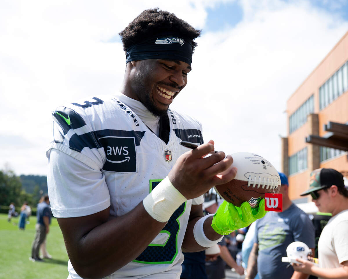 Seattle Seahawks safety Nick Emmanwori (3) signs autographs after training camp at Virginia Mason Athletic Center on Friday, July 25, 2025, in Renton, Wash.