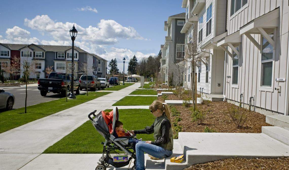 Tatiana Robles and her son Anton sit on her stoop in the newly-built Town Center housing development on Joint Base Lewis McChord in 2011.