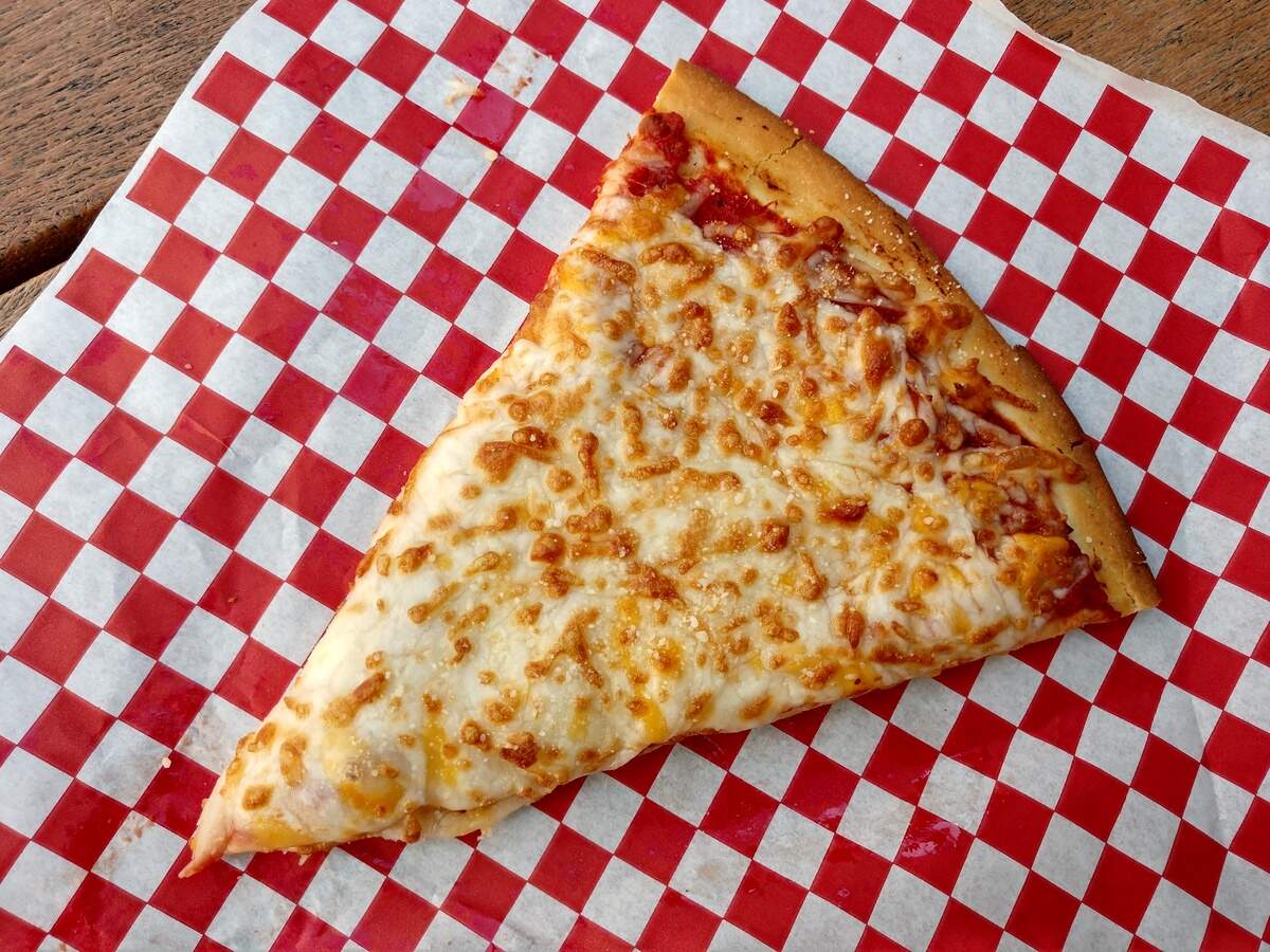 A slice of cheese pizza from Aronica’s Pizza inside the Fair Food Court building.