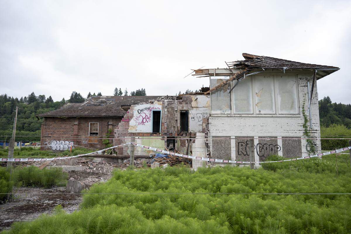 The 111-year-old Alderton School stands halfway demolished on Tuesday, May 19, 2026, after an order was issued to stop the demolition.