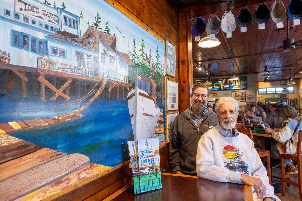 Dylan Stanley, left, bought the restaurant from his dad, Peter Stanley, in 2012. The duo talked to The News Tribune for the Tides’ 50th anniversary in 2023.