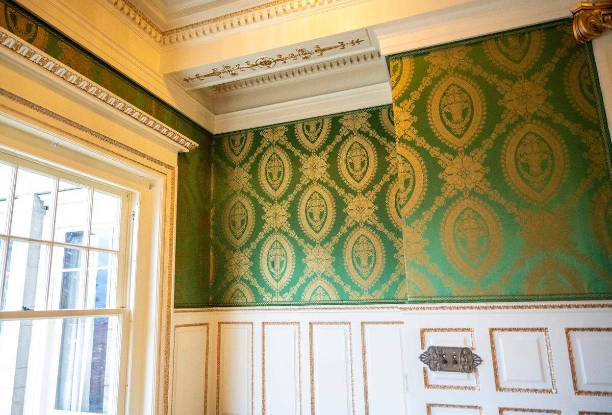 A view of original European silk wall covering found in storage and restored in the great room of the original Rust Mansion.