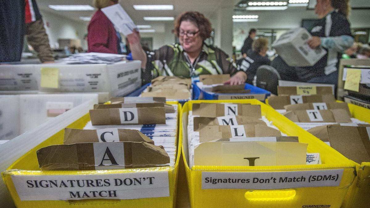 Tori Bonnicksen sorts through ballots where the signatures didn’t match the Pierce County election’s database Nov. 2, 2016 at the Pierce County Elections Center in Tacoma.