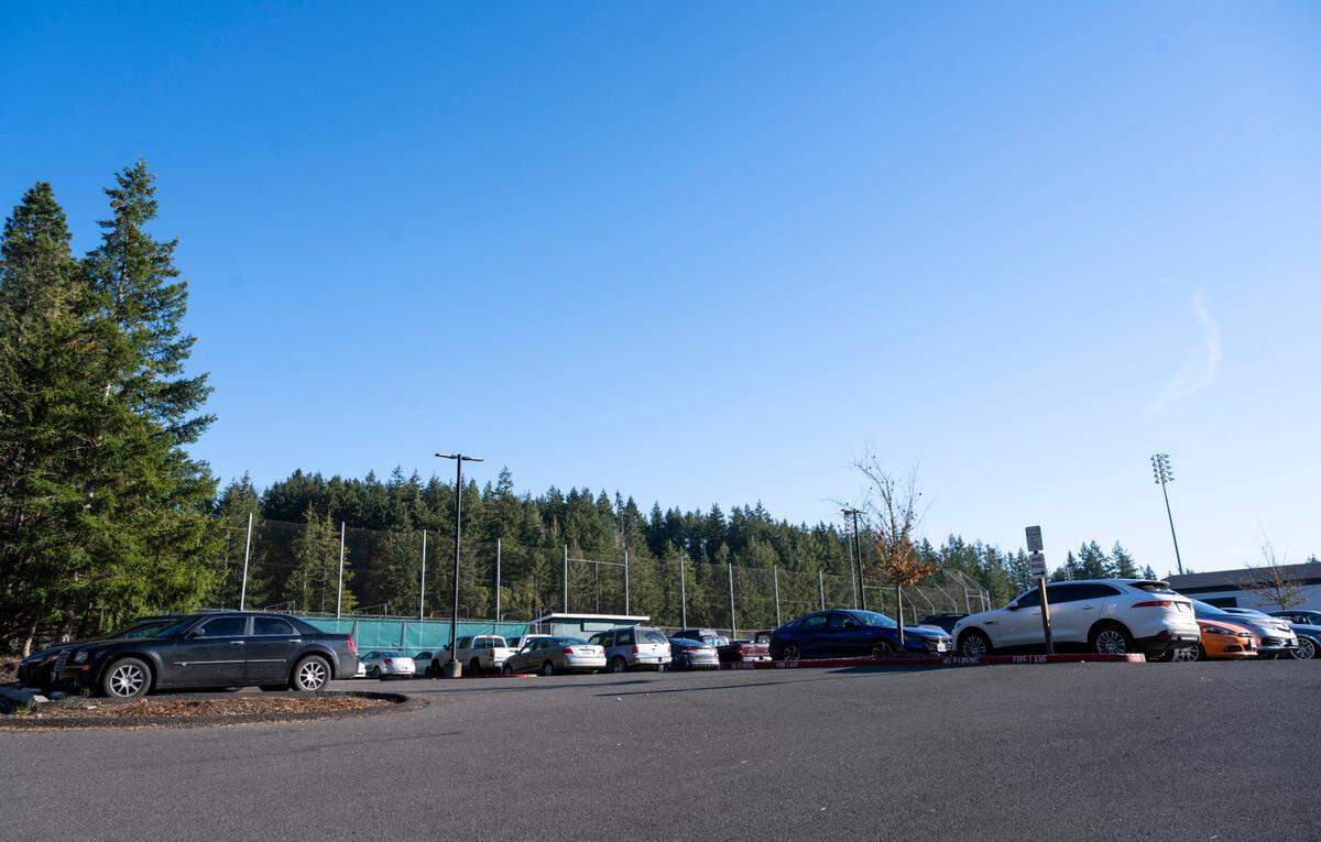 The student parking lot behind the Peninsula High School is full of student vehicles during school hours on Monday, Nov. 14, 2022 in Purdy, Wash.