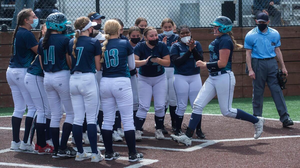 Auburn Riverside’s Emily Blubaugh is greeted by her teammates after hitting a two-run homer in the bottom of the sixth inning to give the Ravens a 4-3 lead. Photo taken at the NPSL softball championship game between Tahoma and Auburn Riverside on Saturday, May 22 at Auburn Riverside High School.