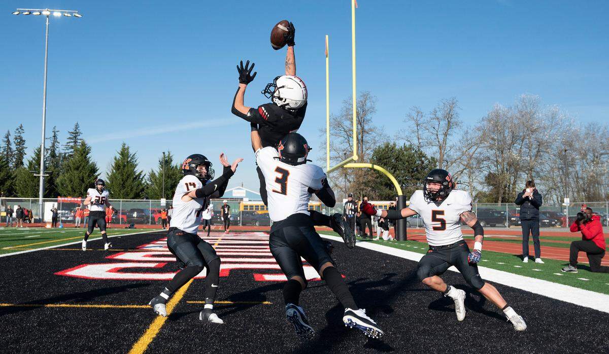 Yelm wide receiver Kyler Ronquillo elevates over Kennewick defenders Ambrose Driver (14), Aiden Garcia (3) and Ayden Metz for a fourth-down touchdown reception during Saturday afternoon’s 3A football state quarterfinal game at Yelm High School in Yelm, Washington, Nov. 19, 2022. Yelm won the game, 36-27.