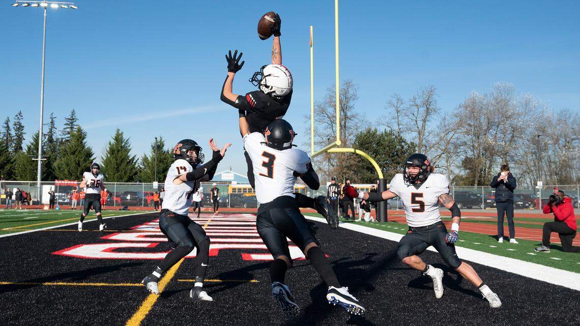 Yelm wide receiver Kyler Ronquillo elevates over Kennewick defenders Ambrose Driver (14), Aiden Garcia (3) and Ayden Metz for a fourth-down touchdown reception during Saturday afternoon’s 3A football state quarterfinal game at Yelm High School in Yelm, Washington, Nov. 19, 2022. Yelm won the game, 36-27.