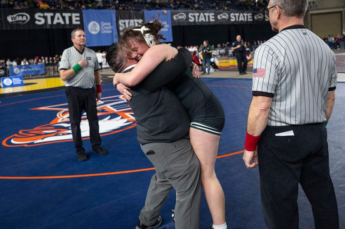 Peninsula’s Lindsey Shipp hugs one of her coaches after defeating Kennewick’s Jaylee Lopez to win the Class 3A, 170-pound state title on Friday, Feb. 21, 2025, at Mat Classic XXXVI at the Tacoma Dome in Tacoma, Wash.