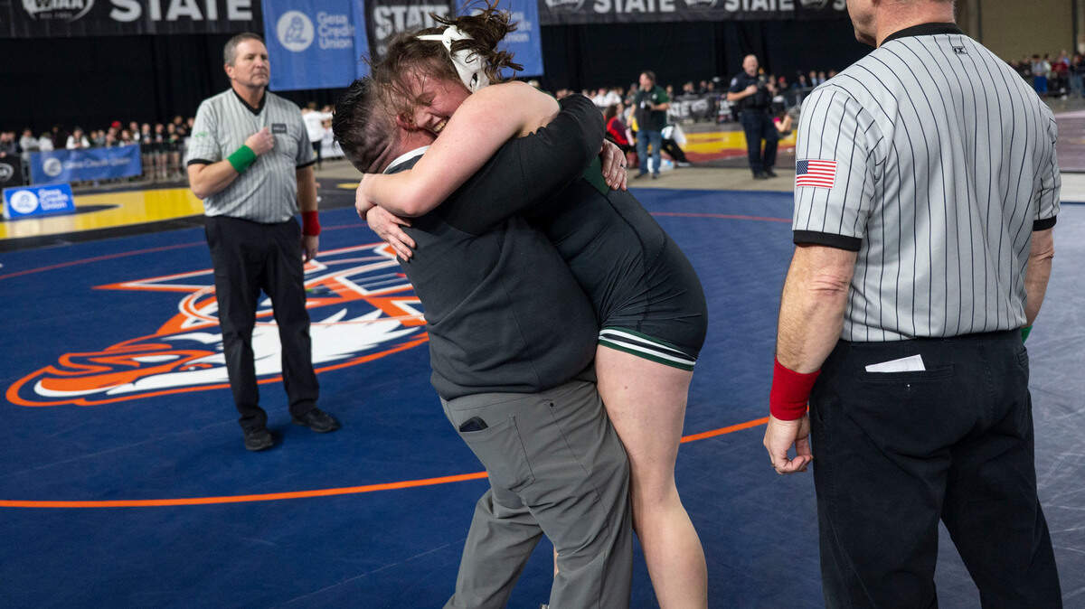 Peninsula’s Lindsey Shipp hugs one of her coaches after defeating Kennewick’s Jaylee Lopez to win the Class 3A, 170-pound state title on Friday, Feb. 21, 2025, at Mat Classic XXXVI at the Tacoma Dome in Tacoma, Wash.