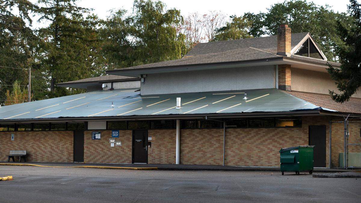 Tarps cover portions of the roof of the Lakewood Pierce County Library in Lakewood, Washington, which has been closed since June due to the need for major repairs. The building is shown on Saturday, Sept. 24, 2022.