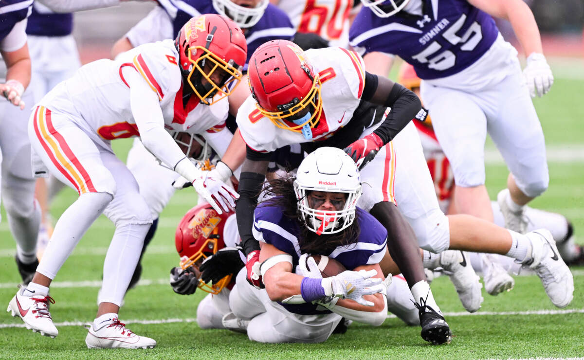 Sumner’s Steele Isaacs (34) goes down under pressure from several Kamiakin defenders during the second half of the game at Sumner High School, on Saturday, Nov. 16, 2024 in Sumner, Wash.