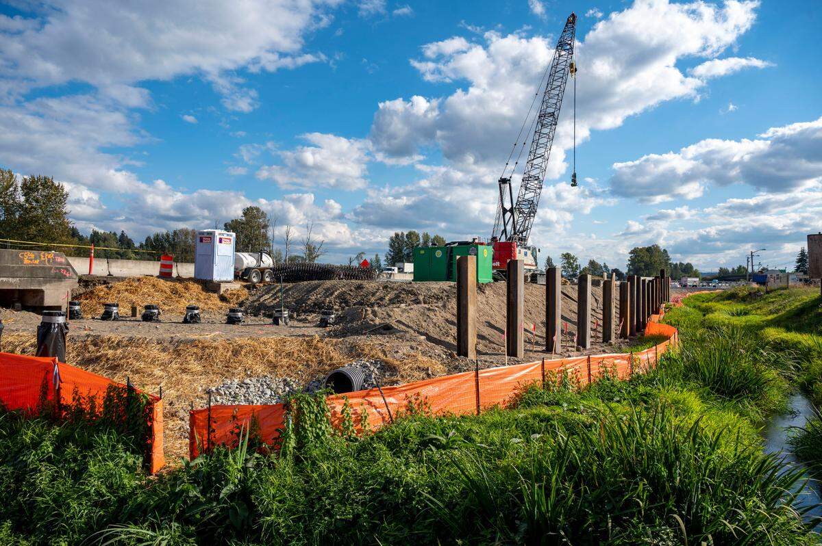 Hylebos Creek runs parallel to Interstate 5 before turning east underneath the busy interstate in Fife on Thursday, Sept. 22, 2022. Washington State Department of Transportation’s 167 Completion Project will help restore the riparian restrain of the creek. Steel piles have been driven into the ground for the expansion of the interstate as work will require the highway to be widened.